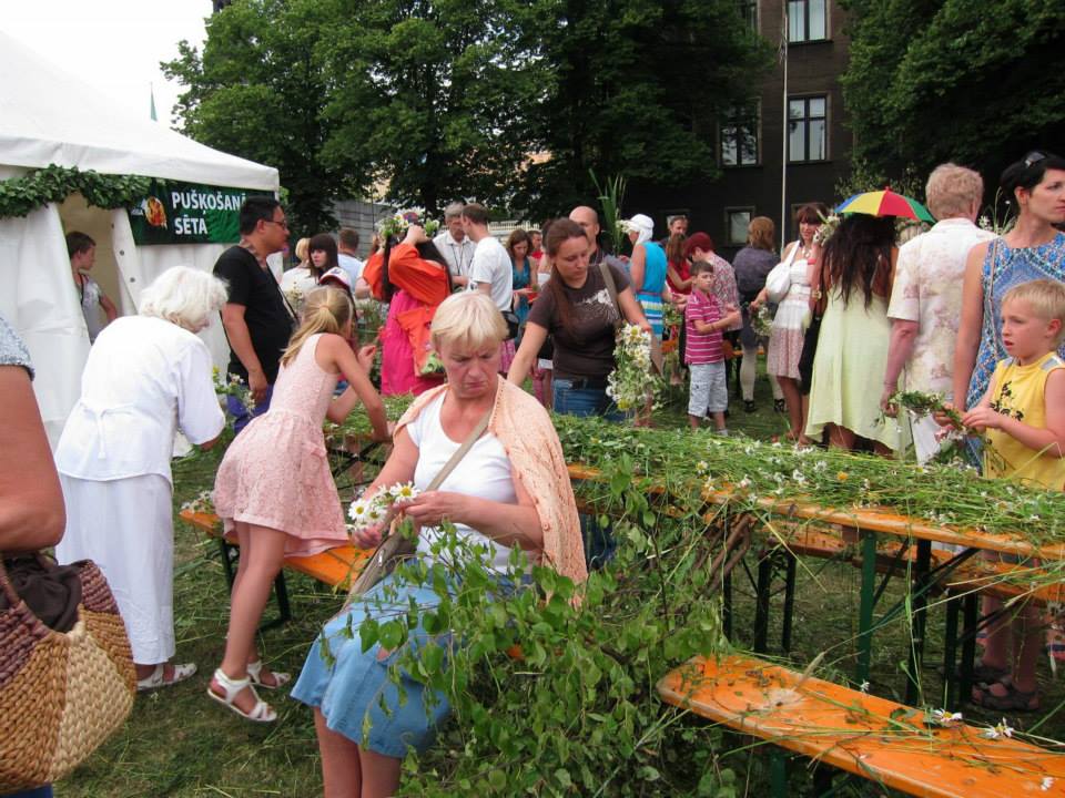 Women weaving garlands.
